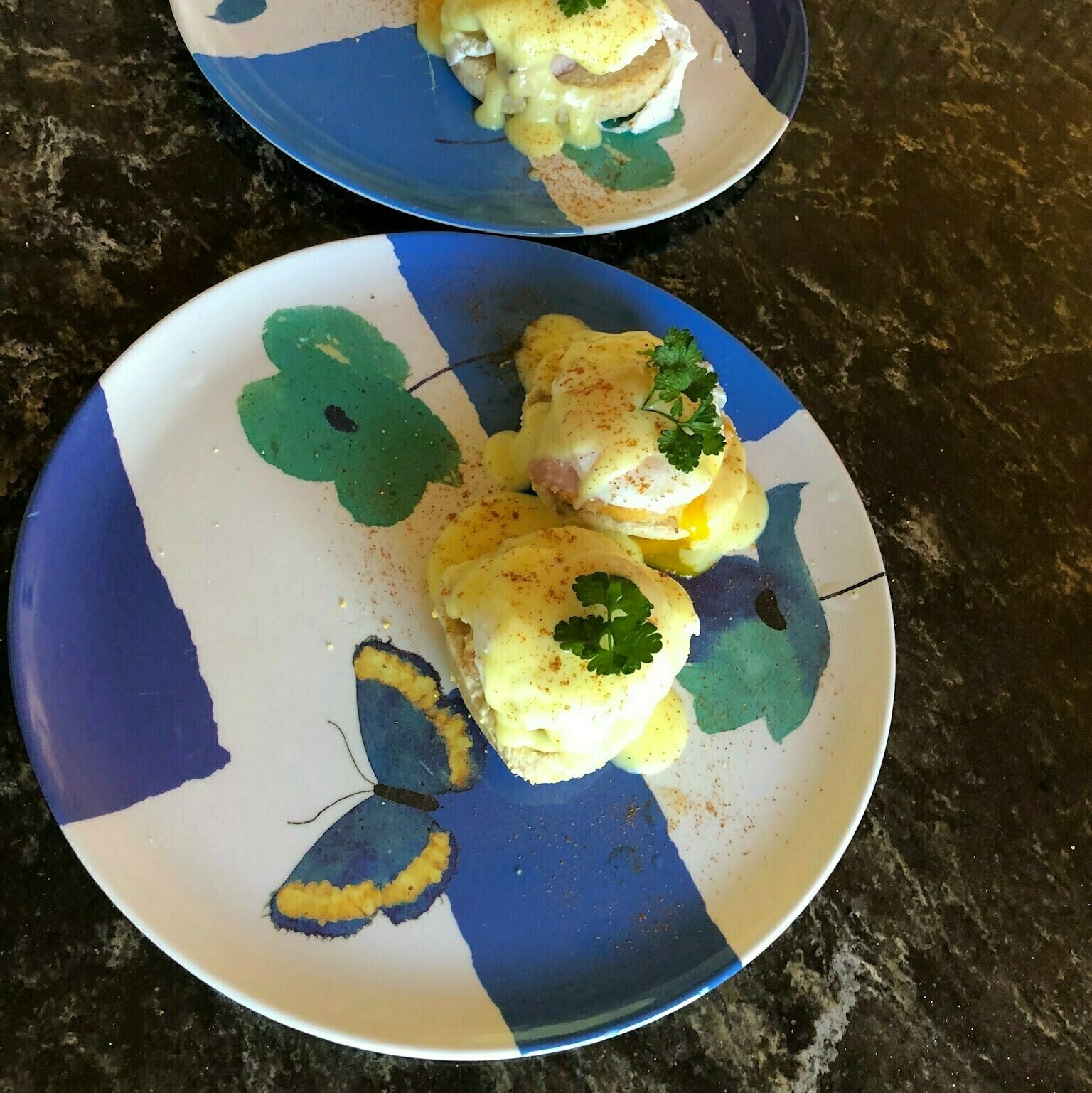 Eggs benedict on a blue and white plate