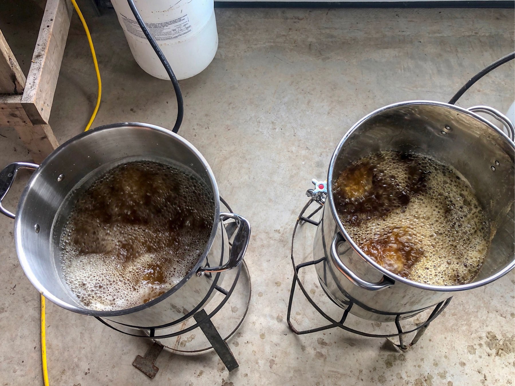 two pots of syrup boiling on propane burners