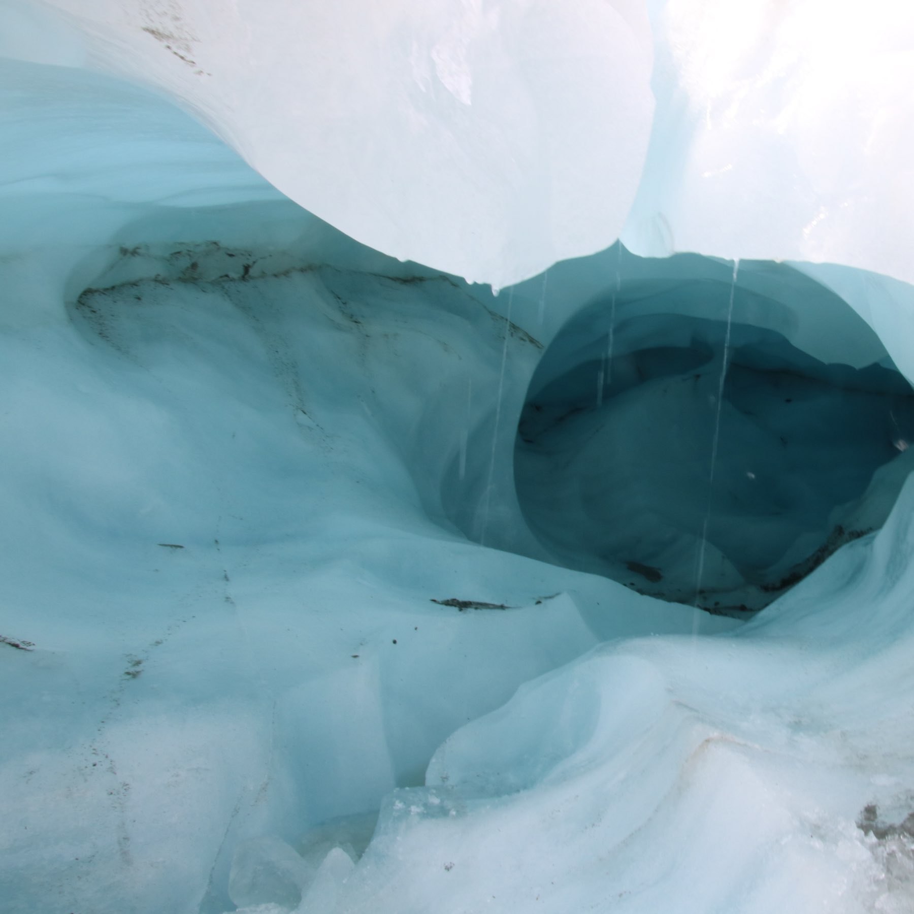 water dripping from a tunnel on a glacier