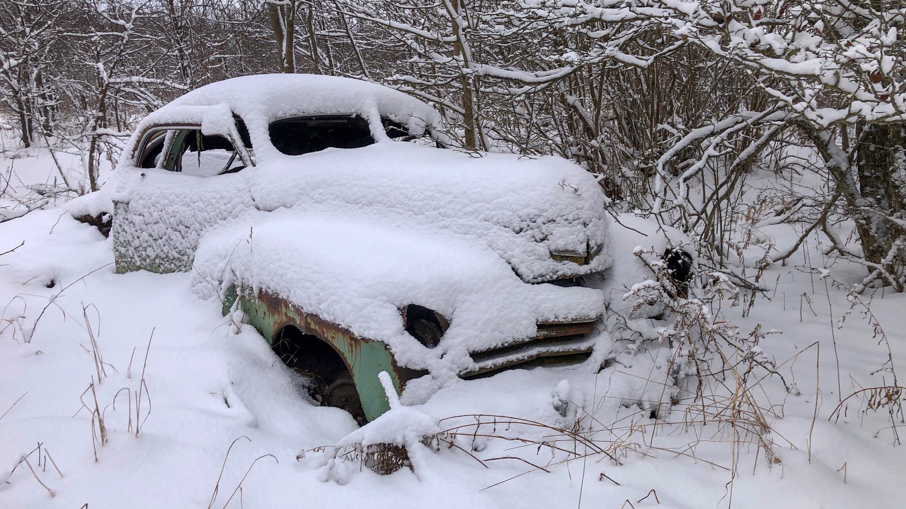old car covered in snow