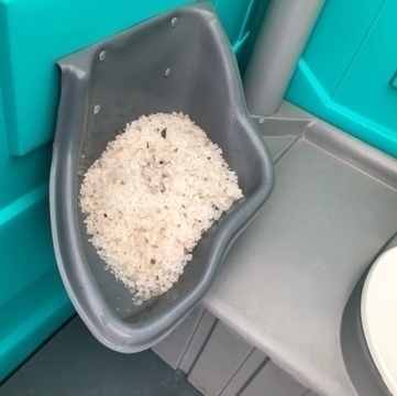 salt-filled urinal in a porta potty