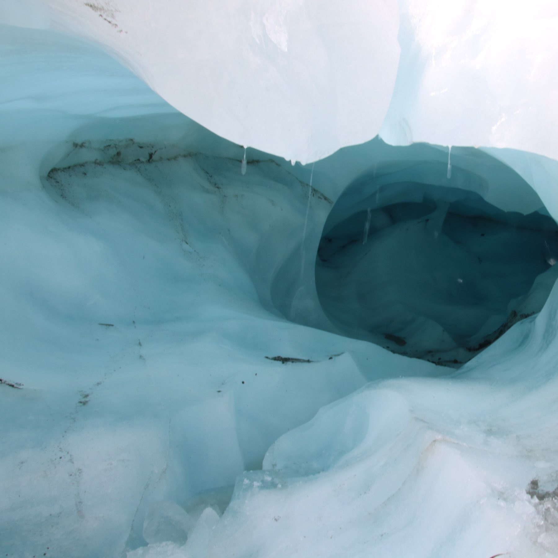 water dripping from a tunnel on a glacier 