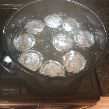 9 jars in a pot of boiling water