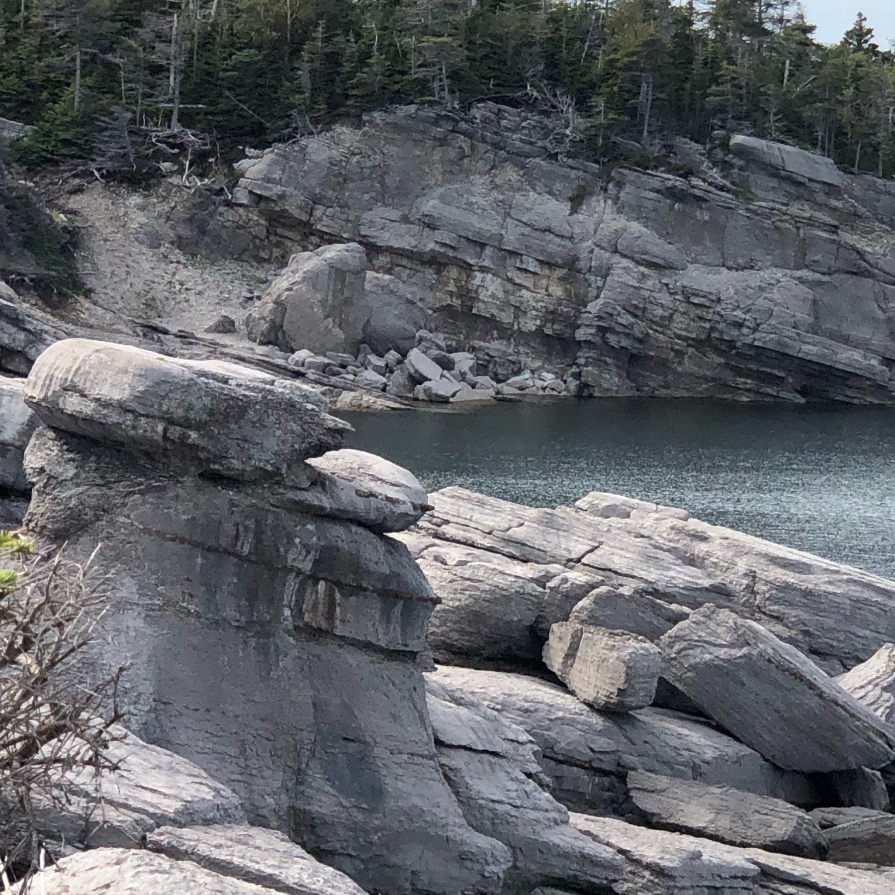 oddly shaped rocks surrounding a cove