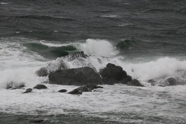 waves splashing around a rock