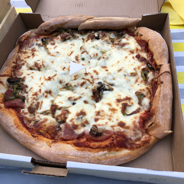 cheesy pizza inside a pizza box