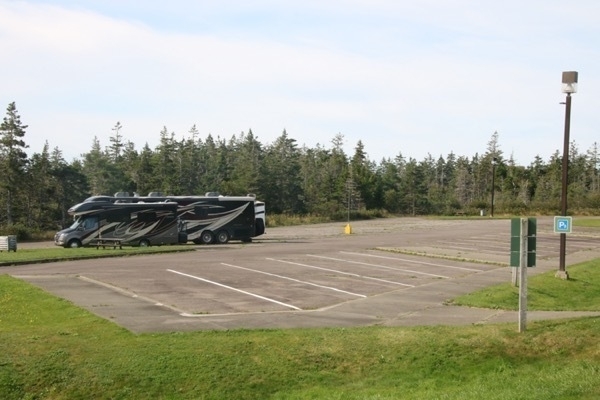 two motorhomes in an otherwise empty, large parking lot