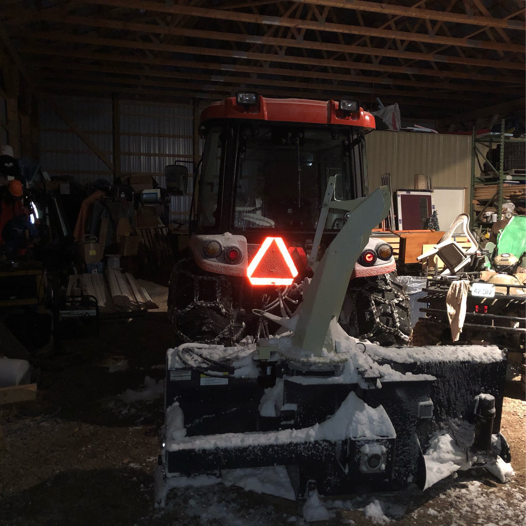 snow covered tractor and blower