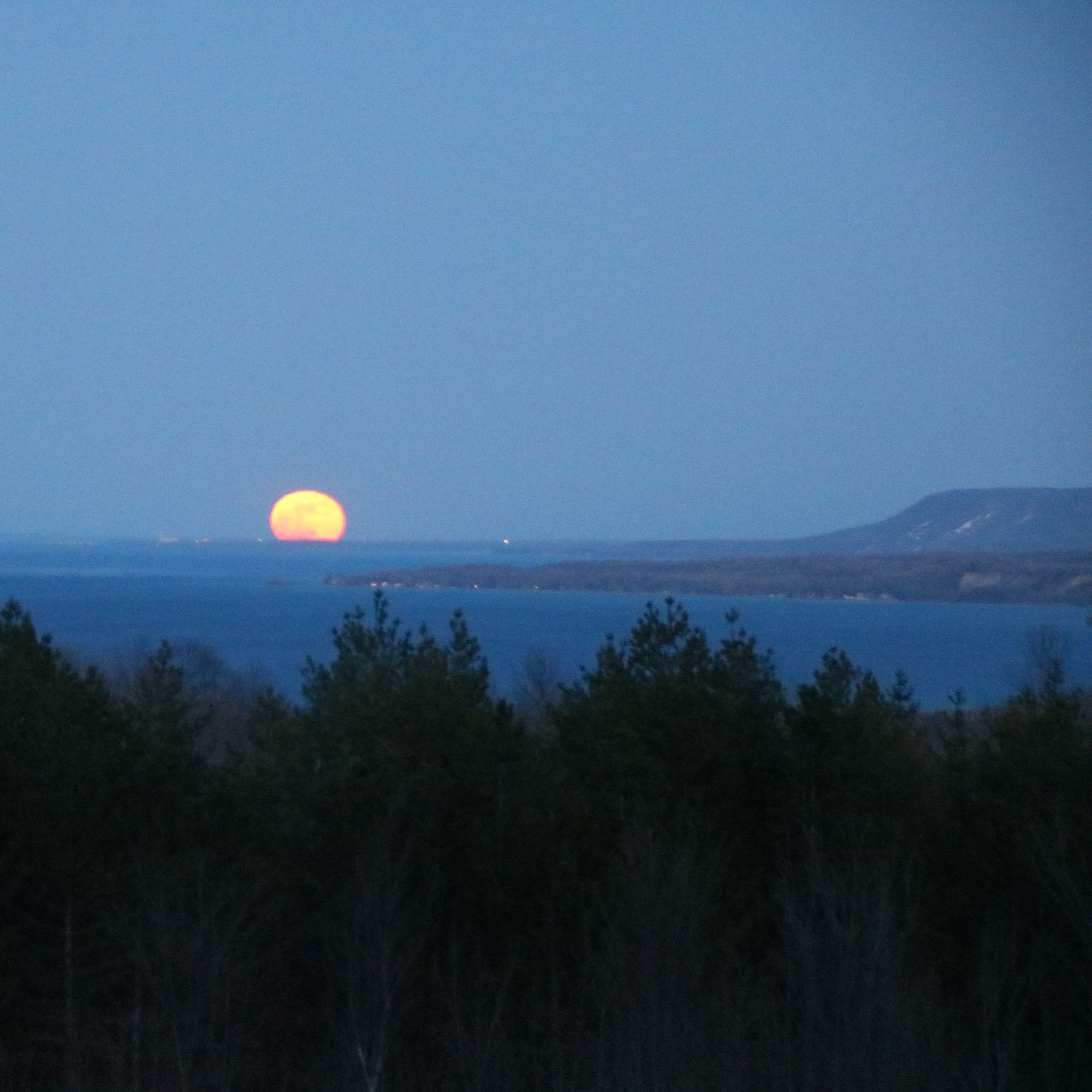 full moon just over the horizon