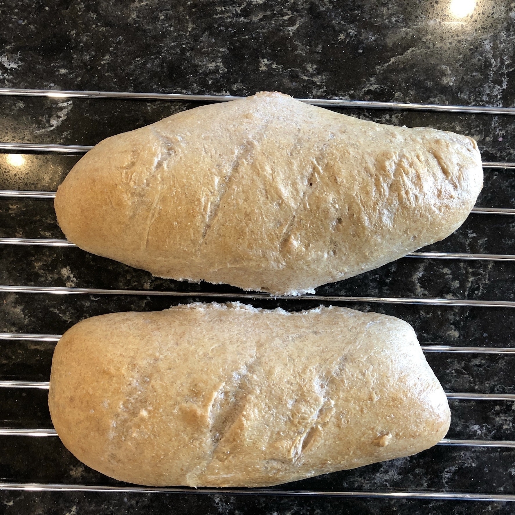 Two French sticks on a cooling rack