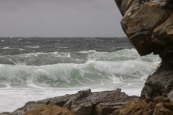 waves framed by a rock