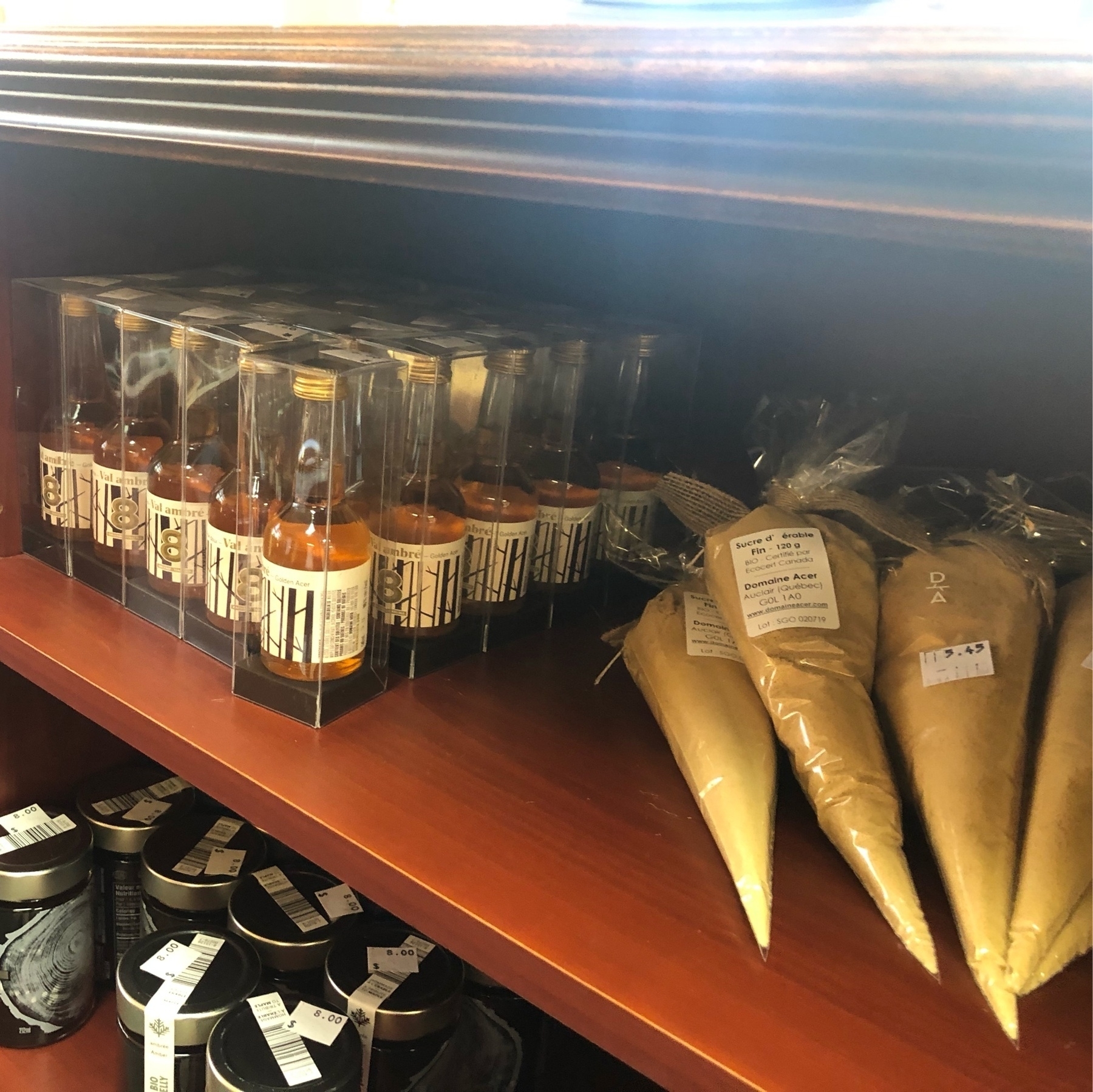 maple sugar in plastic cones and small bottles of maple jelly