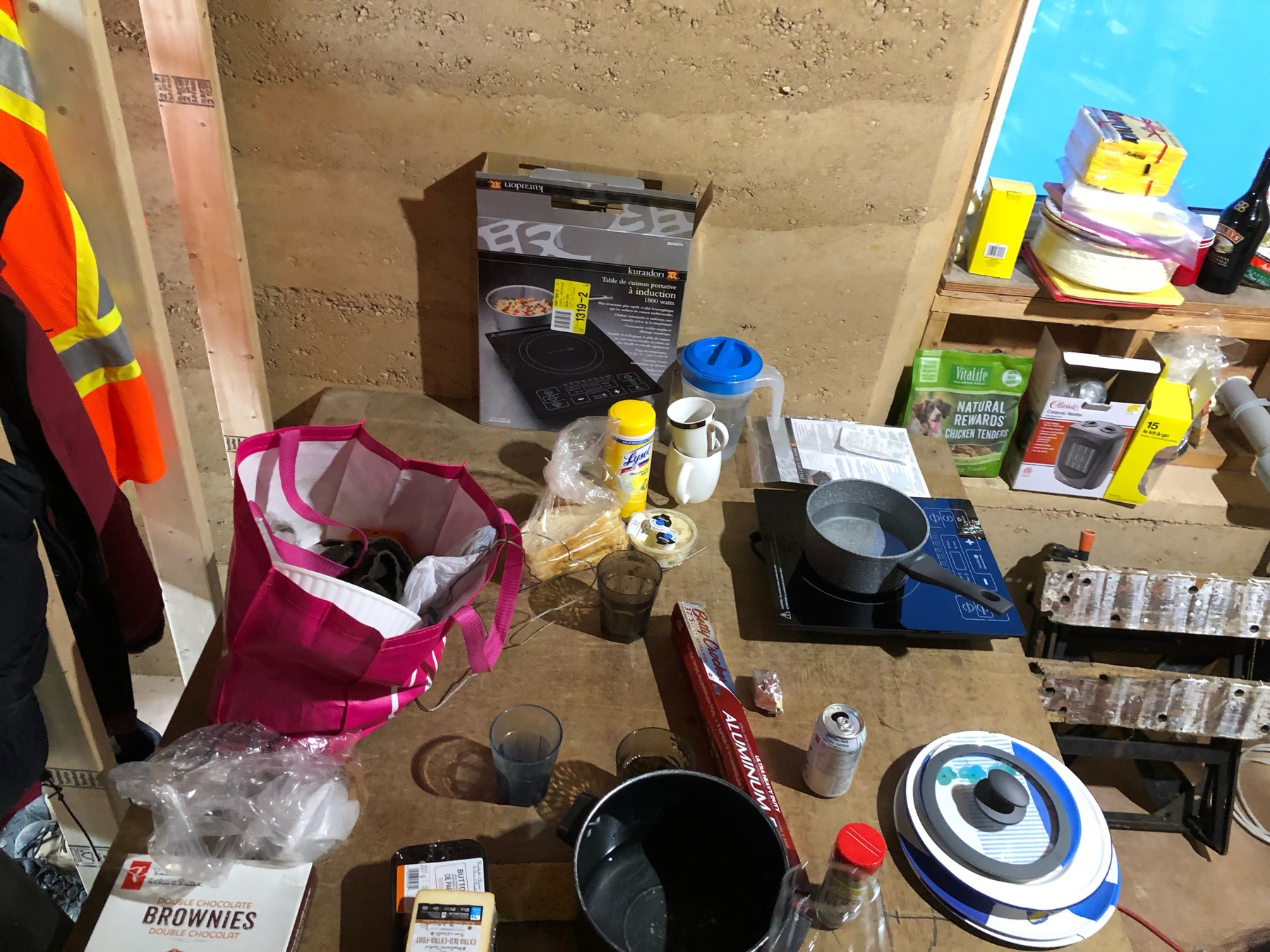 various dishes, pots and pans. there is a pot on an induction cooktop